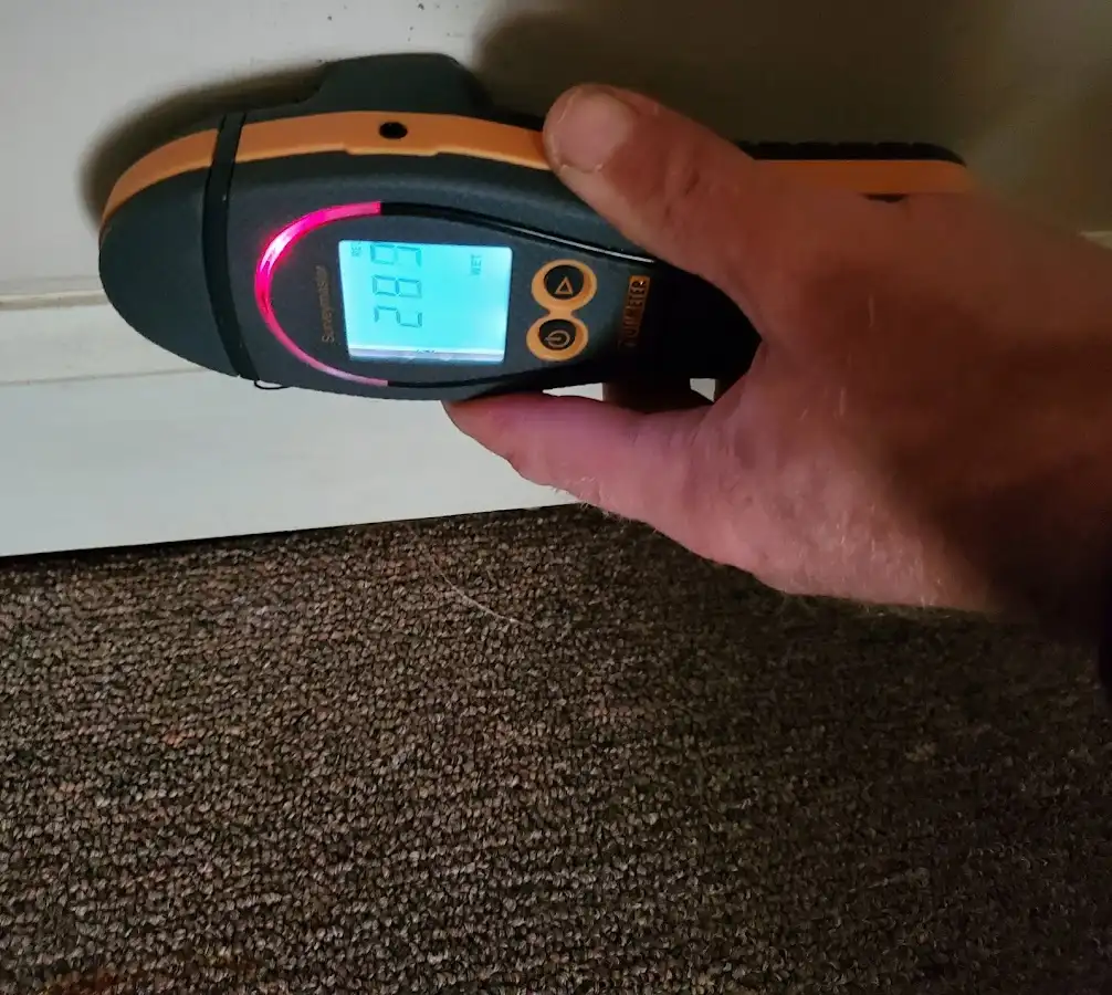Moisture detection at baseboard during Storm Damage Restoration in Colebrookdale